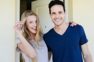 young-couple-hold-keys-to-new-house