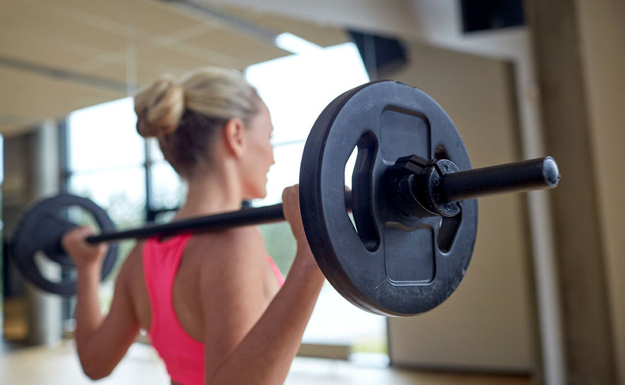 woman-lifts-barbell-behind-shoulders