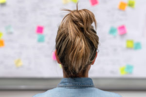 business woman brainstorming product management via whiteboard