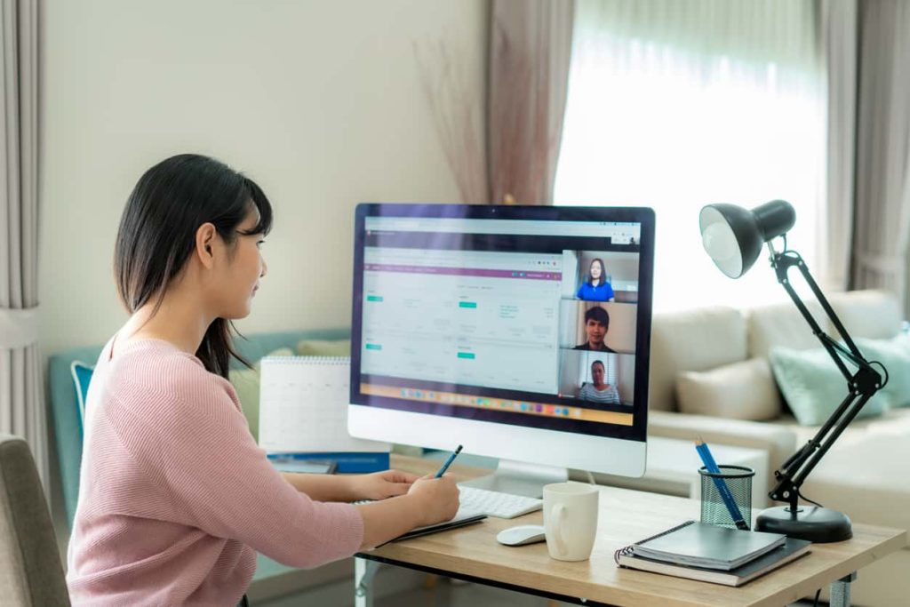 businesswoman on conference call with coworkers working remotely