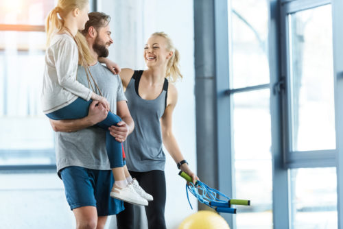 busy mom makes time for fitness with happy family at gym