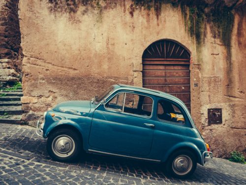 vintage-italian-car-on-cobblestone-road-niche-industry