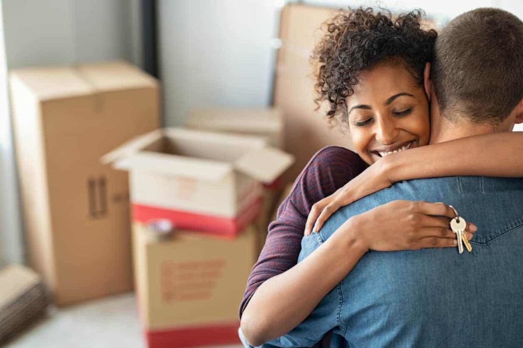 Hugging couple after moving into new home