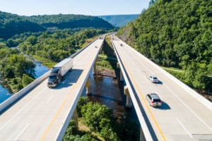 The aerial scenic view of the elevated highway on the high bridge over the Lehigh River at the Pennsylvania Turnpike. Lehigh Valley, Poconos region, Pennsylvania, USA.