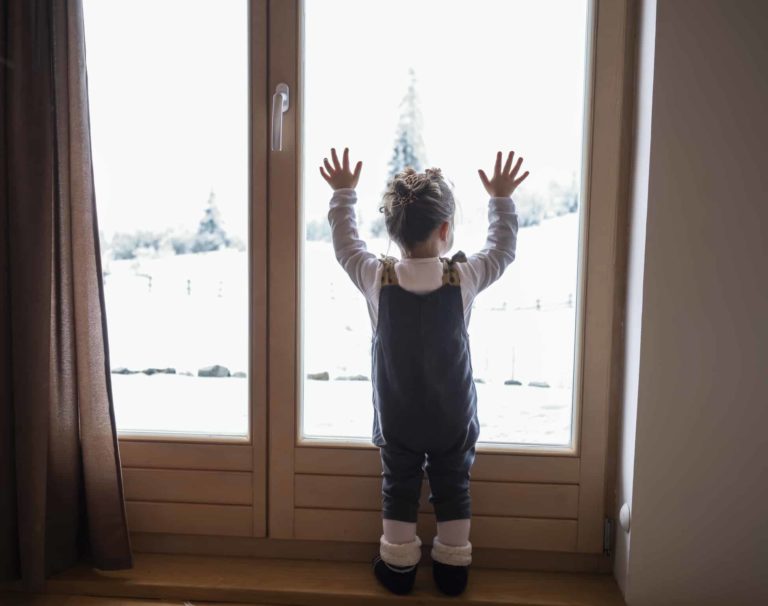 little girl looking out window