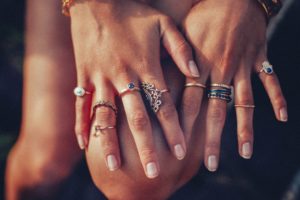 hand-wearing-multiple-pieces-of-jewelry-like-rings-and-bracelets