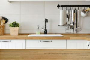 Wooden table with kitchen counter and sink background