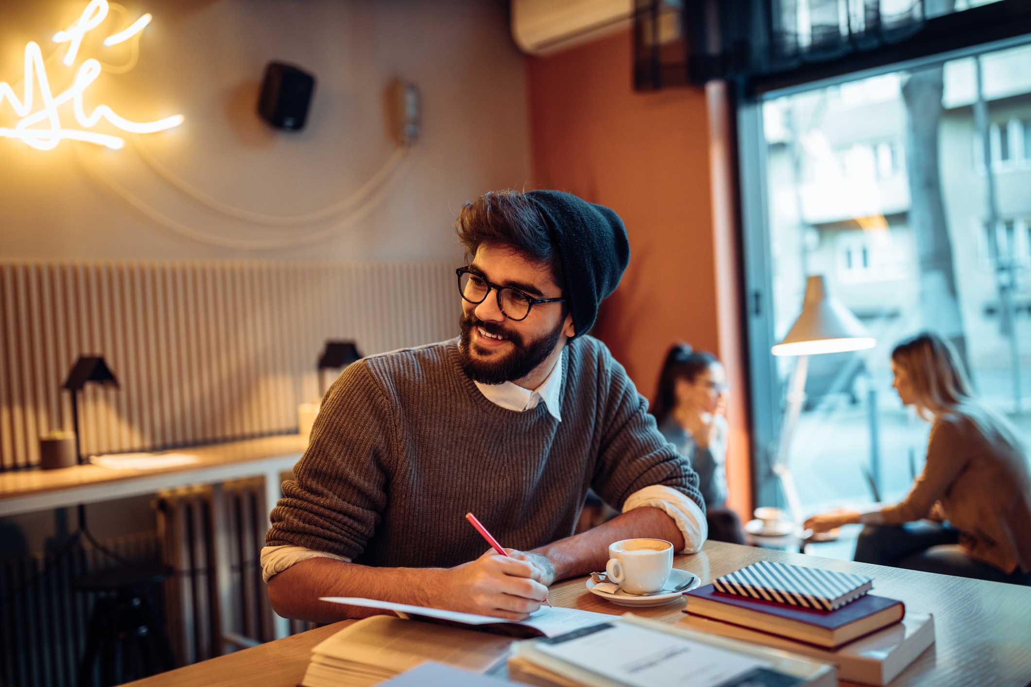 Young man studying in a coffee shop