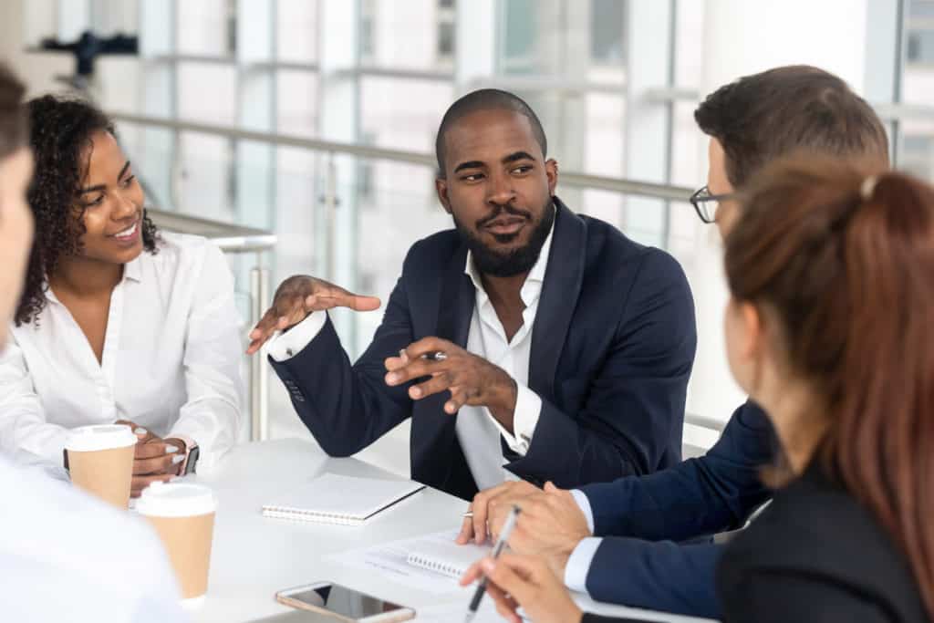 Millennial boss leading a team meeting