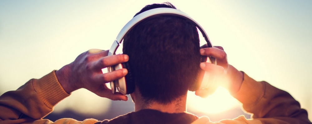 Male-Gen-Z-listening-to-music-through-headphones