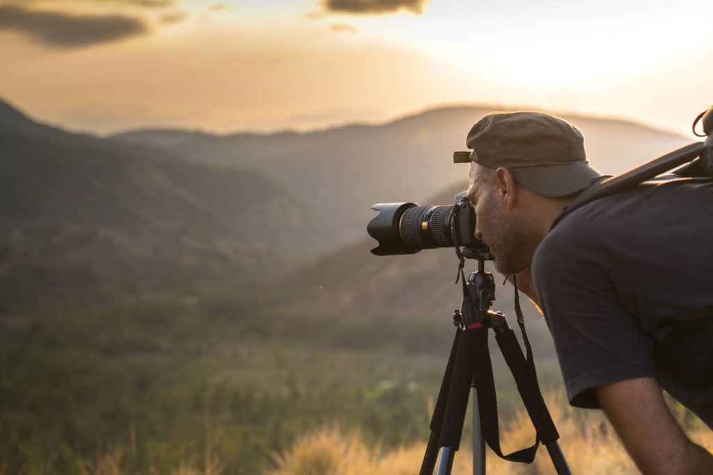 nature photographer taking photo on tripod